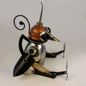 A bird made of a coffee pot, hand trowels and an oil can head.