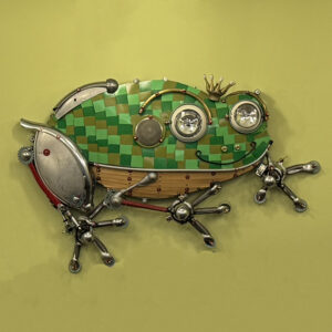 A tree frog made with formica chips, spoons, trampoline springs and motorcycle head lights.