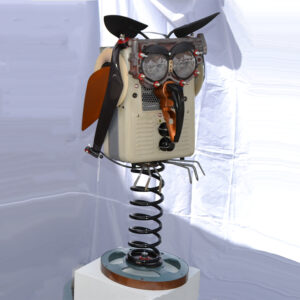 Owl made of space heater, a car spring, garden trowels and miscellaneous parts.