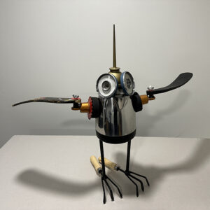 Shore bird built with coffee pot, hockey sticks, and garden rakes.