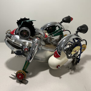 Bullfrog made of garden tools, baking pan, track lights and bicycle parts.